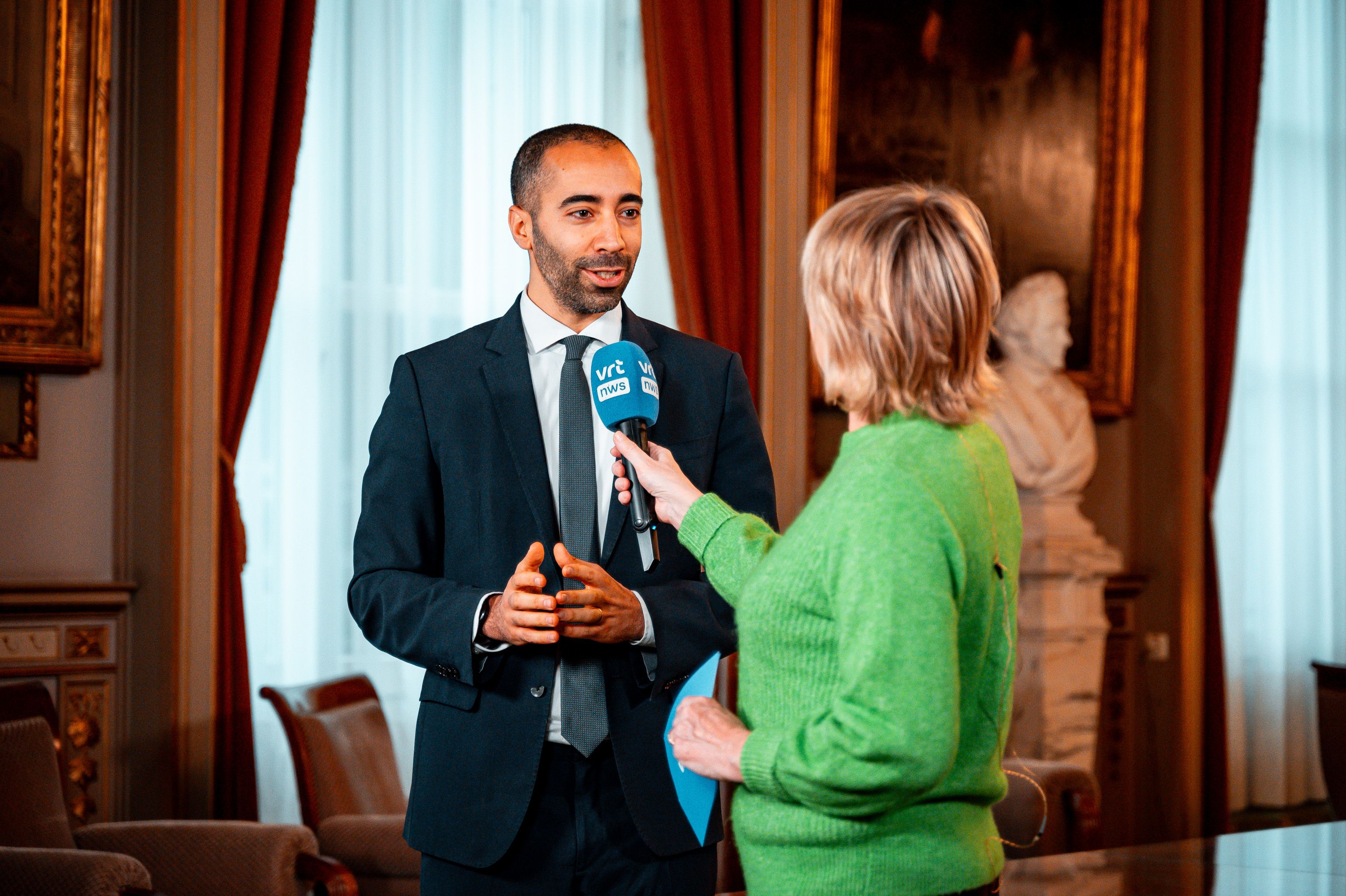 A spokesperson speaking with a journalist at a media event