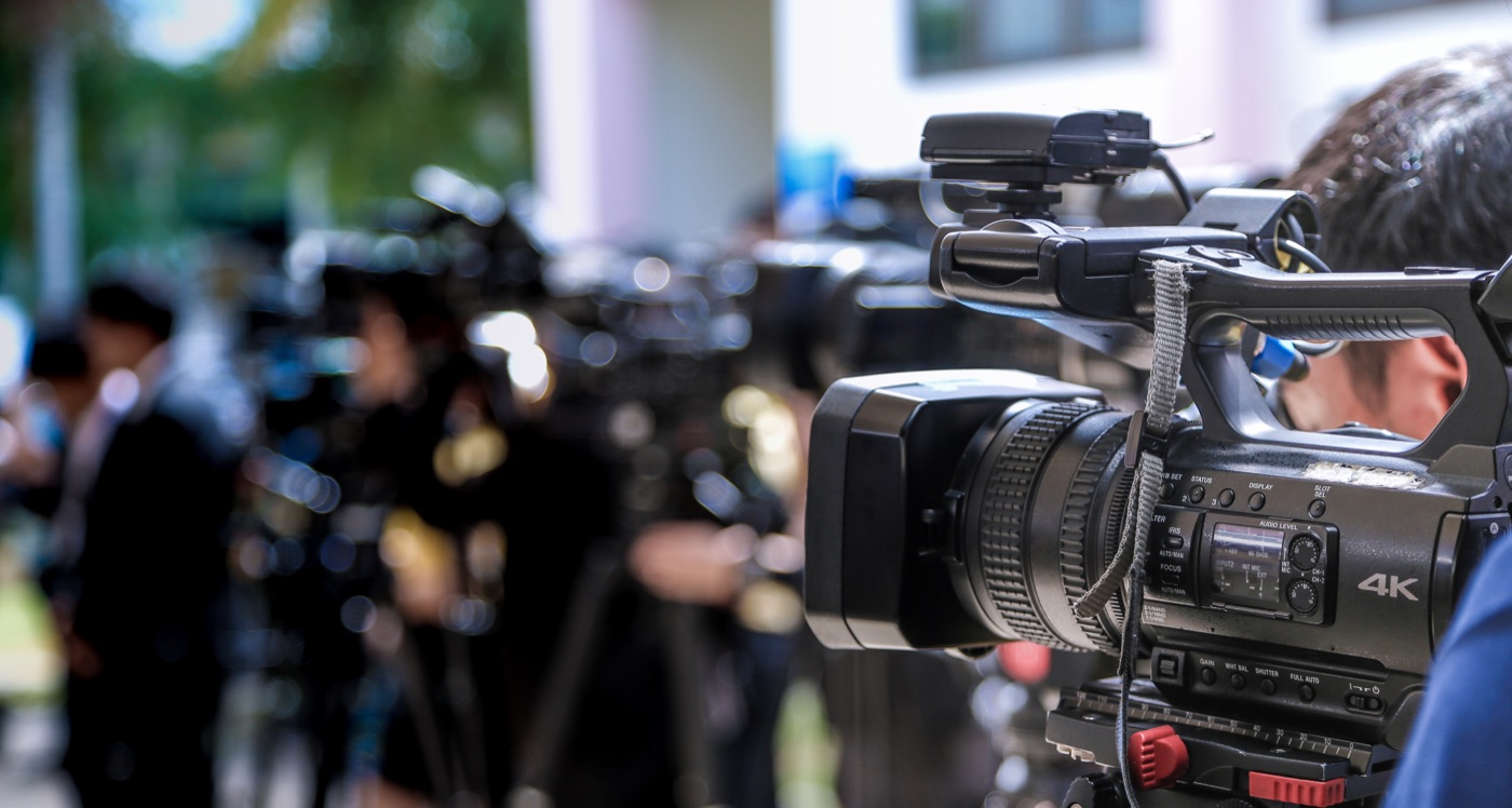 Journalists and camera crews covering a media story