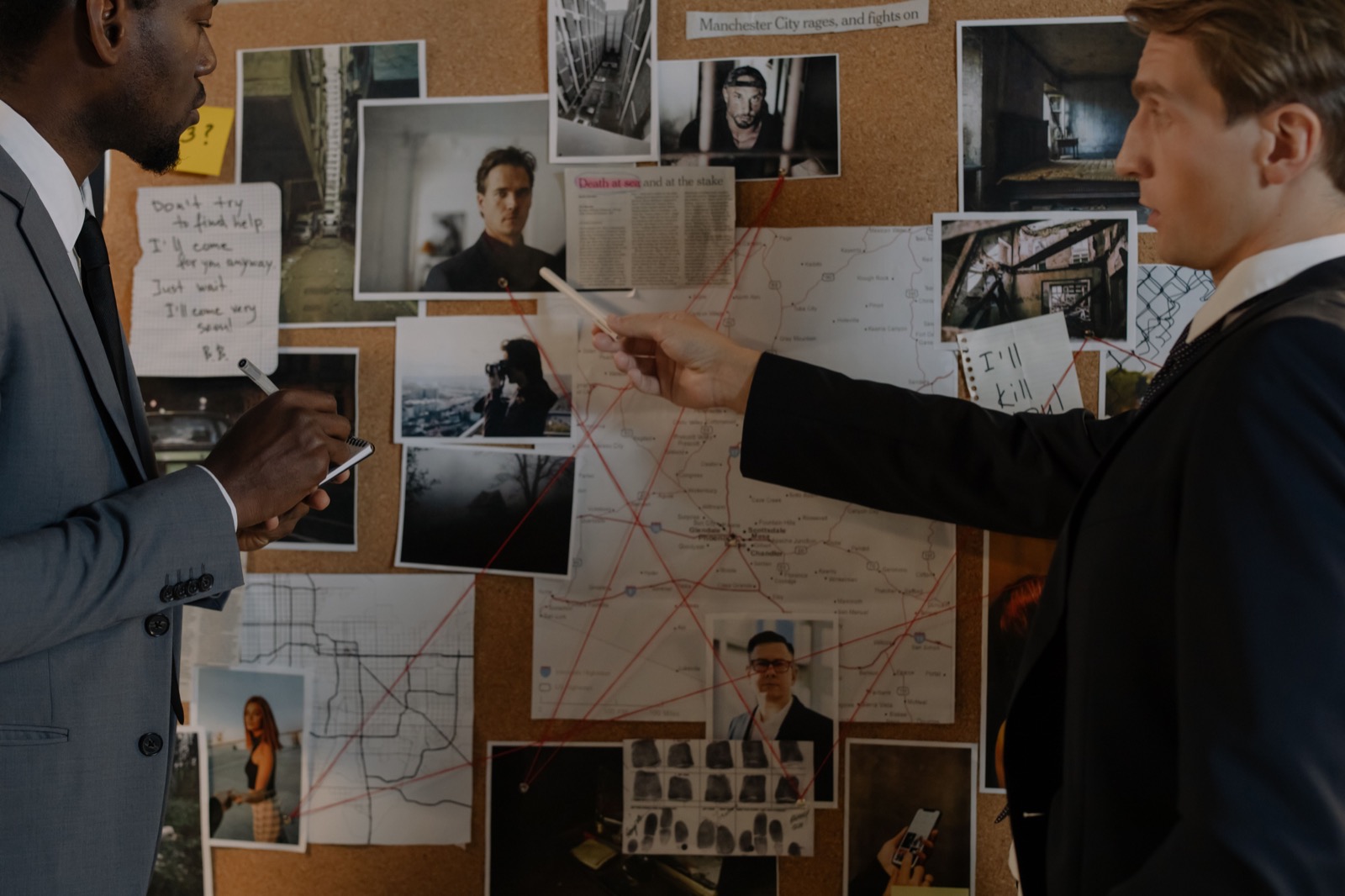A team identifying facts and connections on a story board